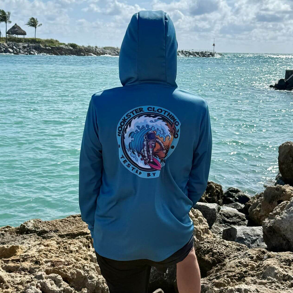 Back view of a man wearing the Astro Wave Men's UV Hoodie with hood up, standing outdoors