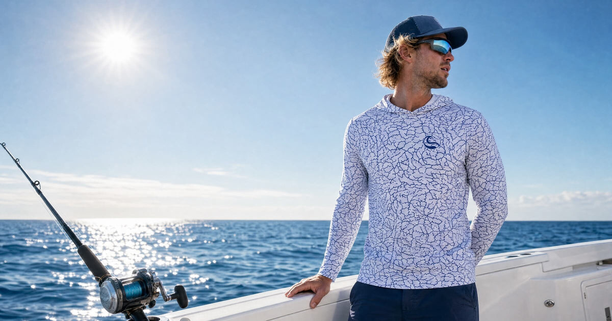 Angler at the gunwale of a center console boat offshore in the HOOKSTER Tide Trace UPF 50+ UV hoodie, sun over open water