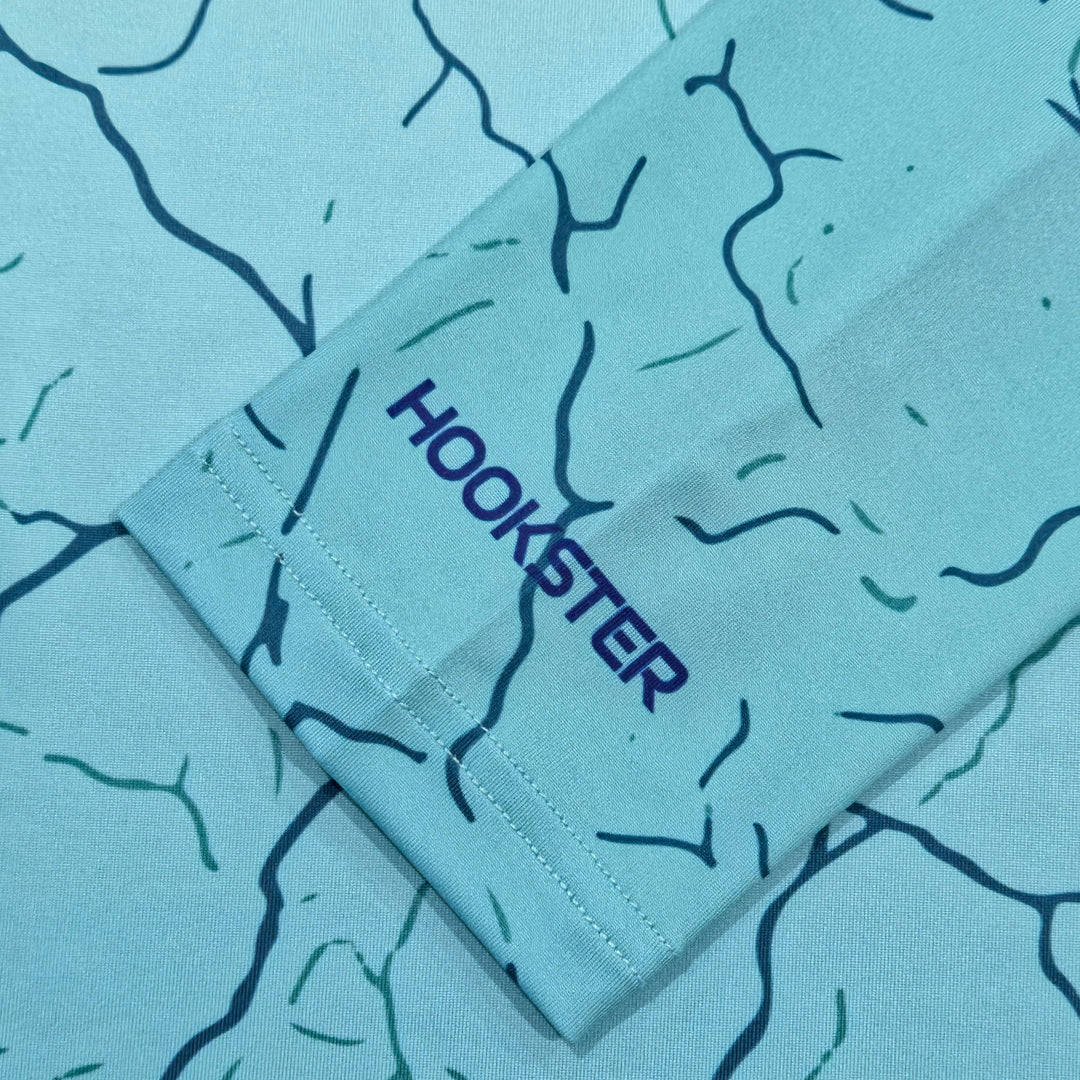 HOOKSTER logo on the sleeve cuff of the Reef Fade UPF 50+ UV hoodie