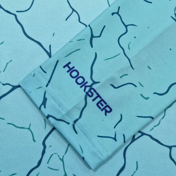 HOOKSTER logo on the sleeve cuff of the Reef Fade UPF 50+ UV hoodie