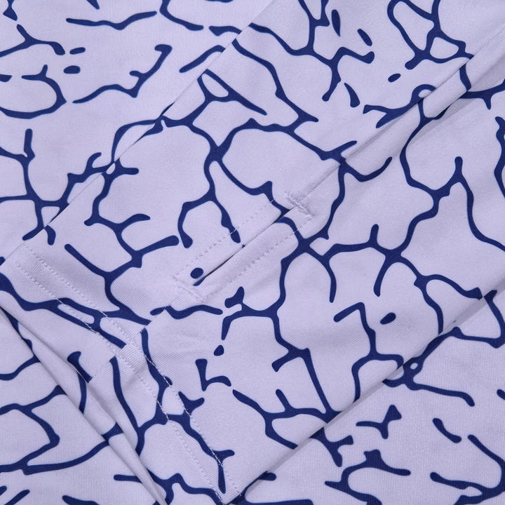 Thumbhole cuff on the Tide Trace UPF 50+ UV hoodie, white with a navy cracked-earth print